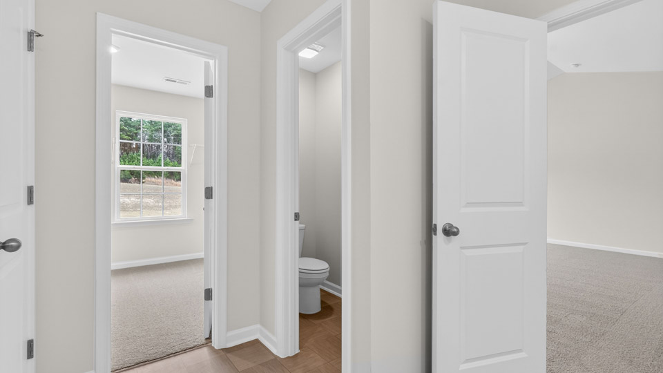 primary bathroom with walk in shower and dual vanity sinks
