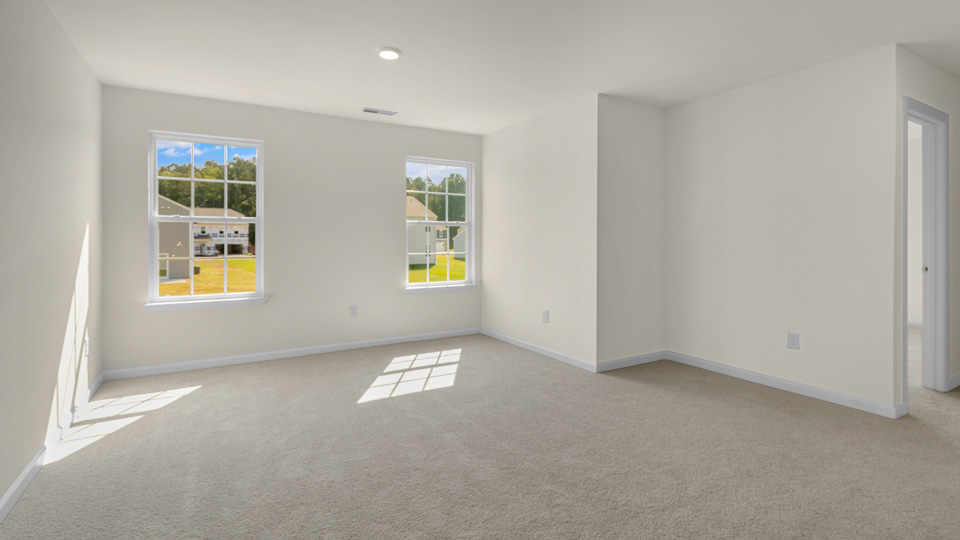 upstairs loft area with large windows and carpeting