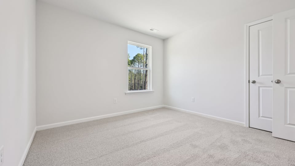 additional bedroom with window, carpeting, closet