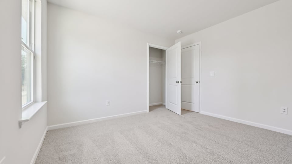 additional bedroom with window, carpeting, closet