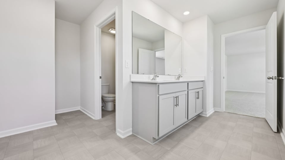 bathroom with lots of natural lighting and quartz countertops