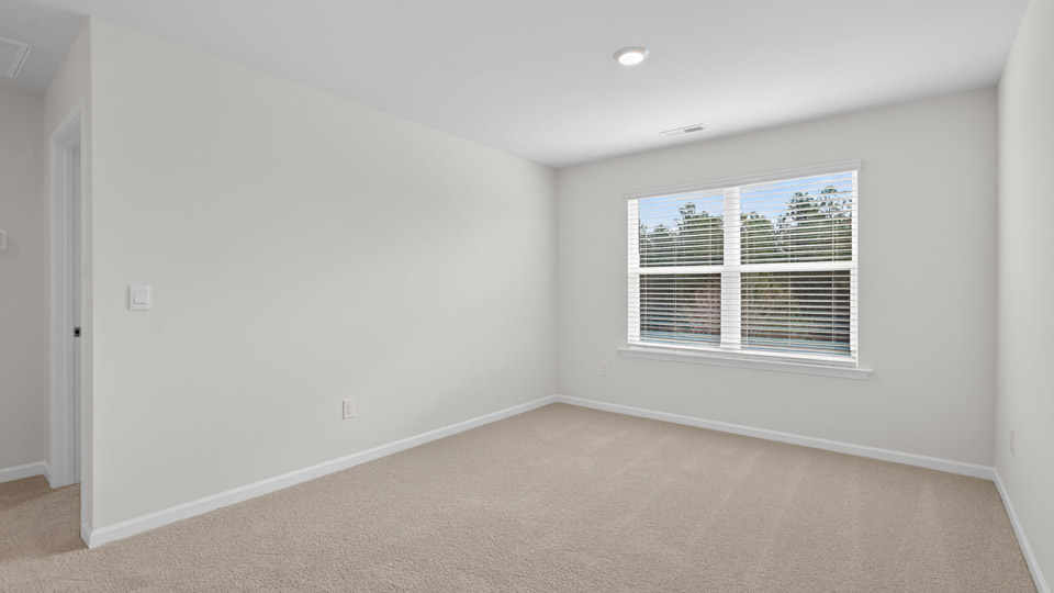 upstairs loft area with large windows and carpeting