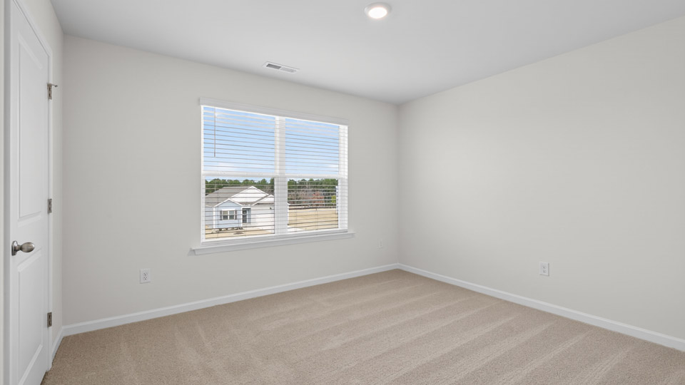 additional bedroom with window, carpeting, closet
