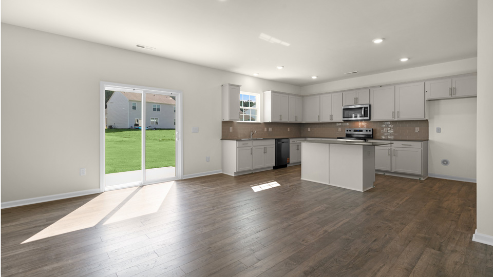open concept kitchen and sliding glass doors to patio