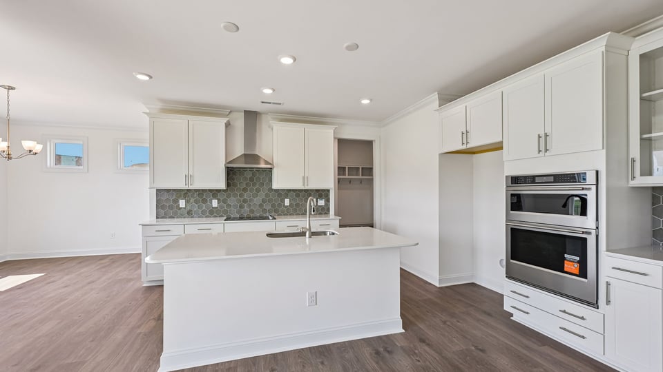 kitchen with white cabinets quartz countertops and center island