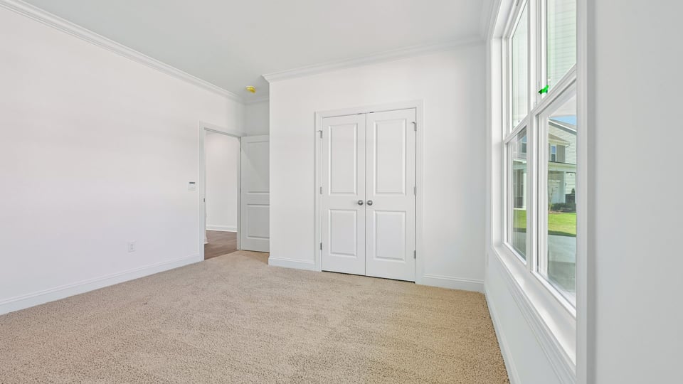 first floor guest bedroom with carpet flooring