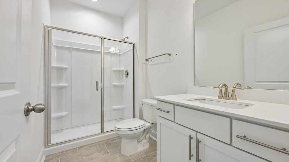 bathroom with walkin shower and dual vanity
