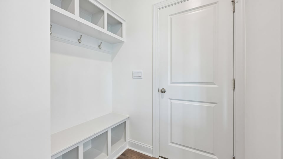 garage entry with dropzone cubbies and bench