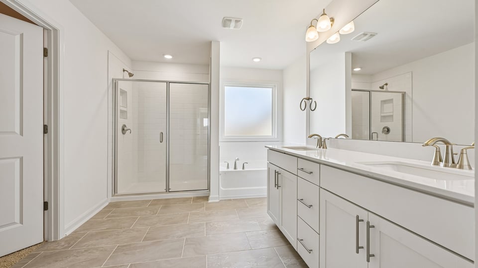 primary bathroom with separate tub and shower
