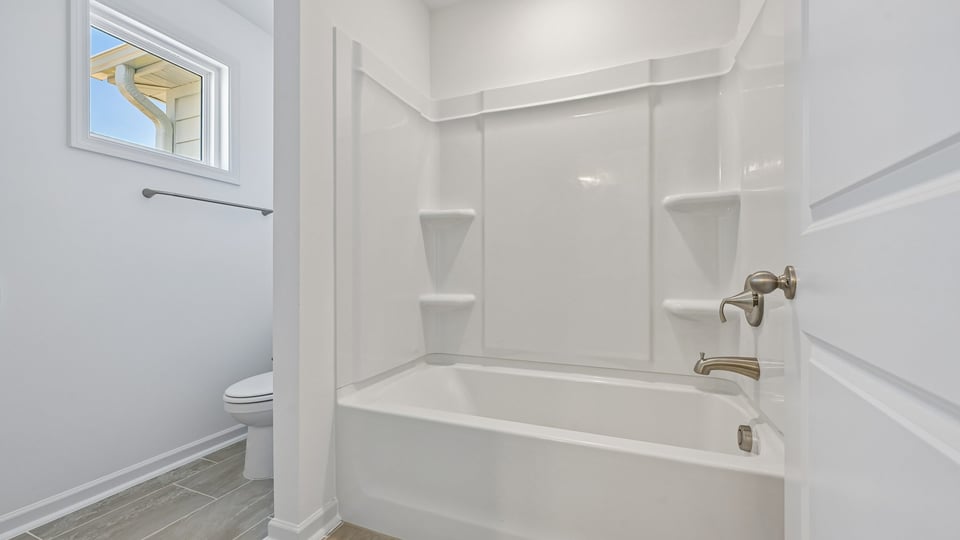 bathroom with tub shower combo and water closet