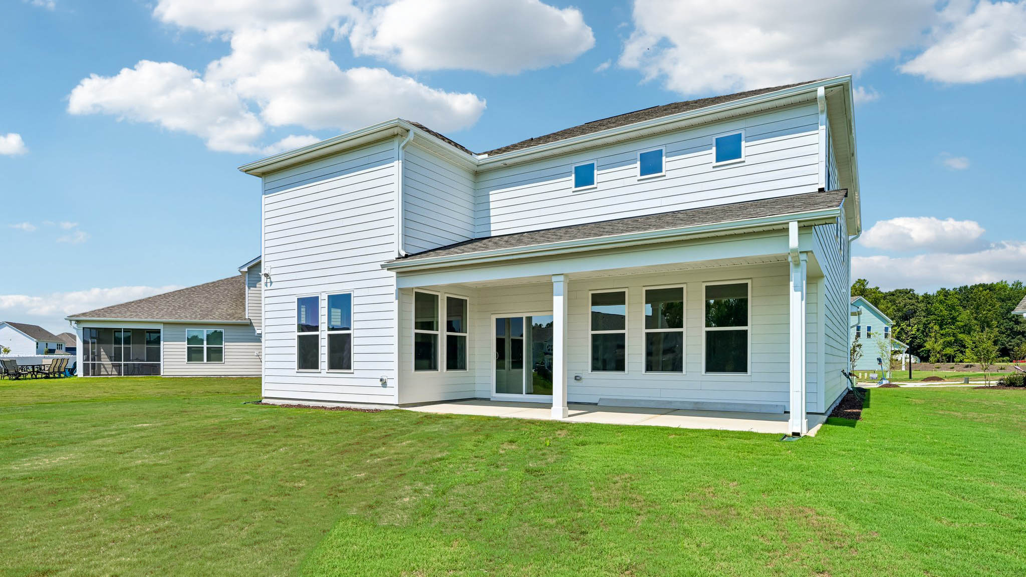 back of home with covered concrete patio
