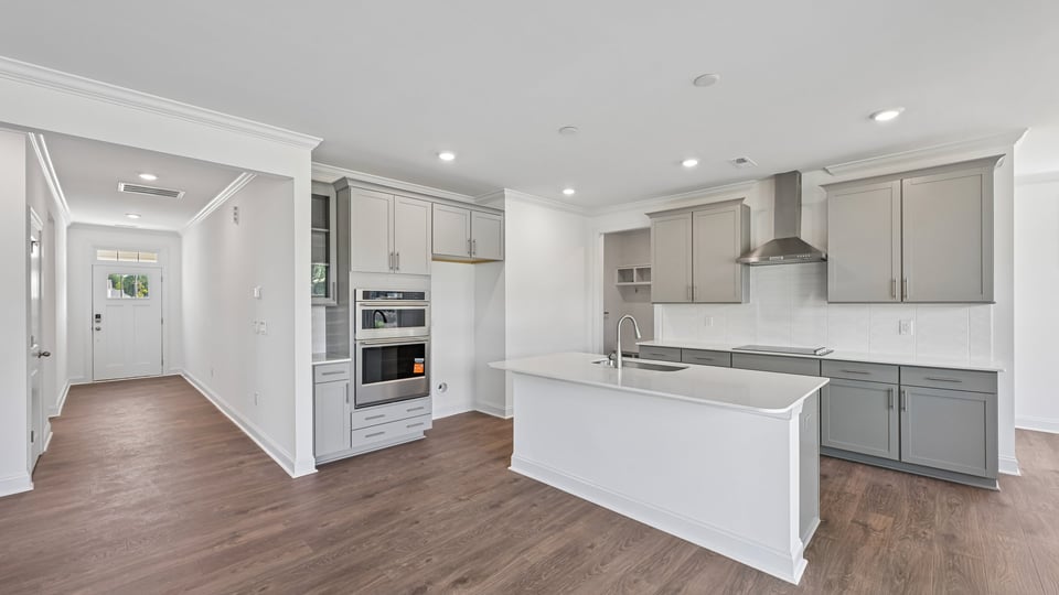 kitchen with gray cabinets center island and quartz countertops
