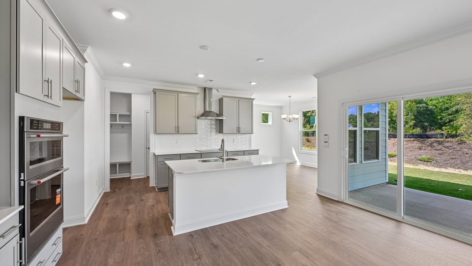 kitchen with gray cabinets center island and quartz countertops