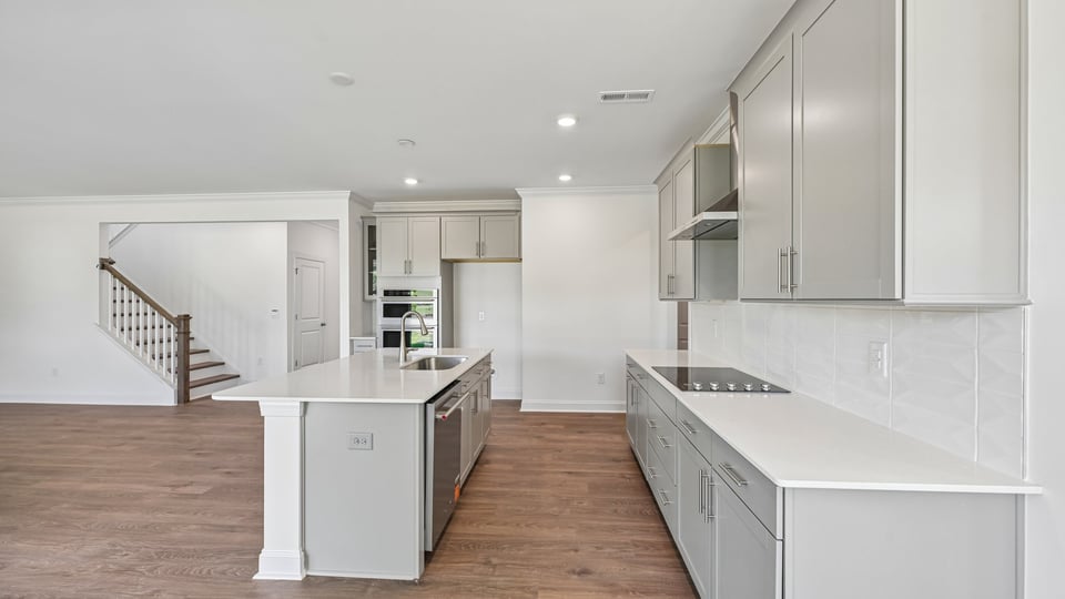 kitchen with gray cabinets center island and quartz countertops