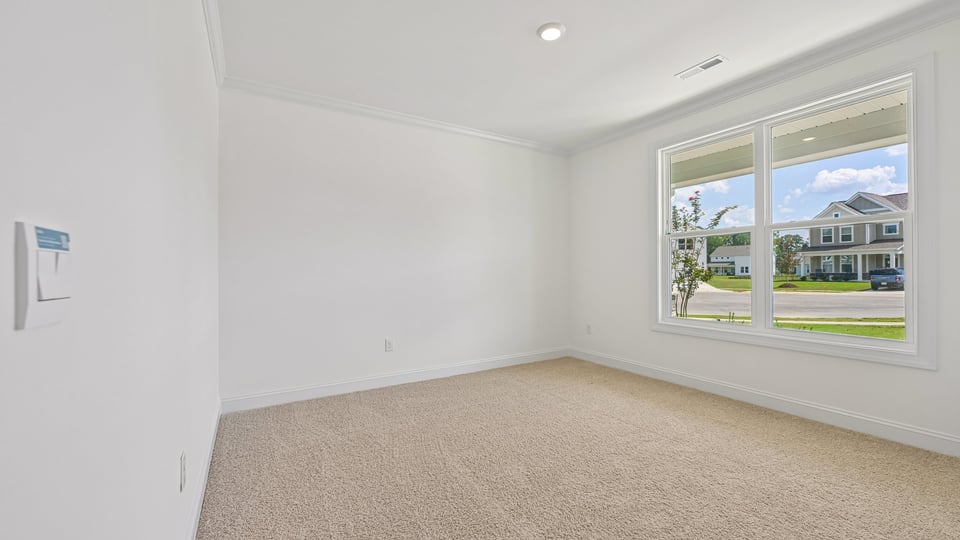first floor guest bedroom with carpet flooring