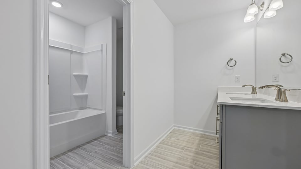 bathroom with tub shower combo and water closet