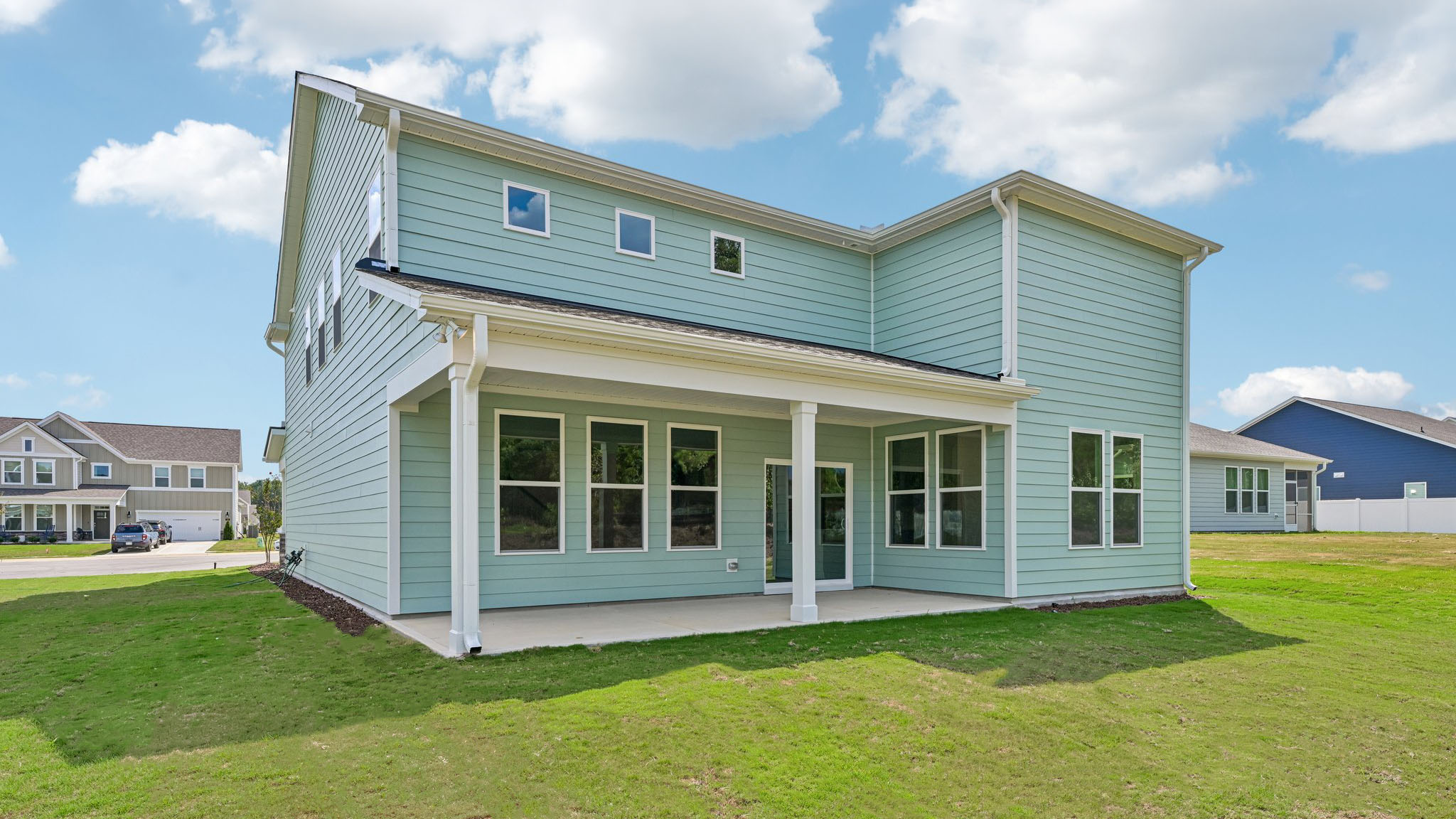 back of home with covered concrete patio