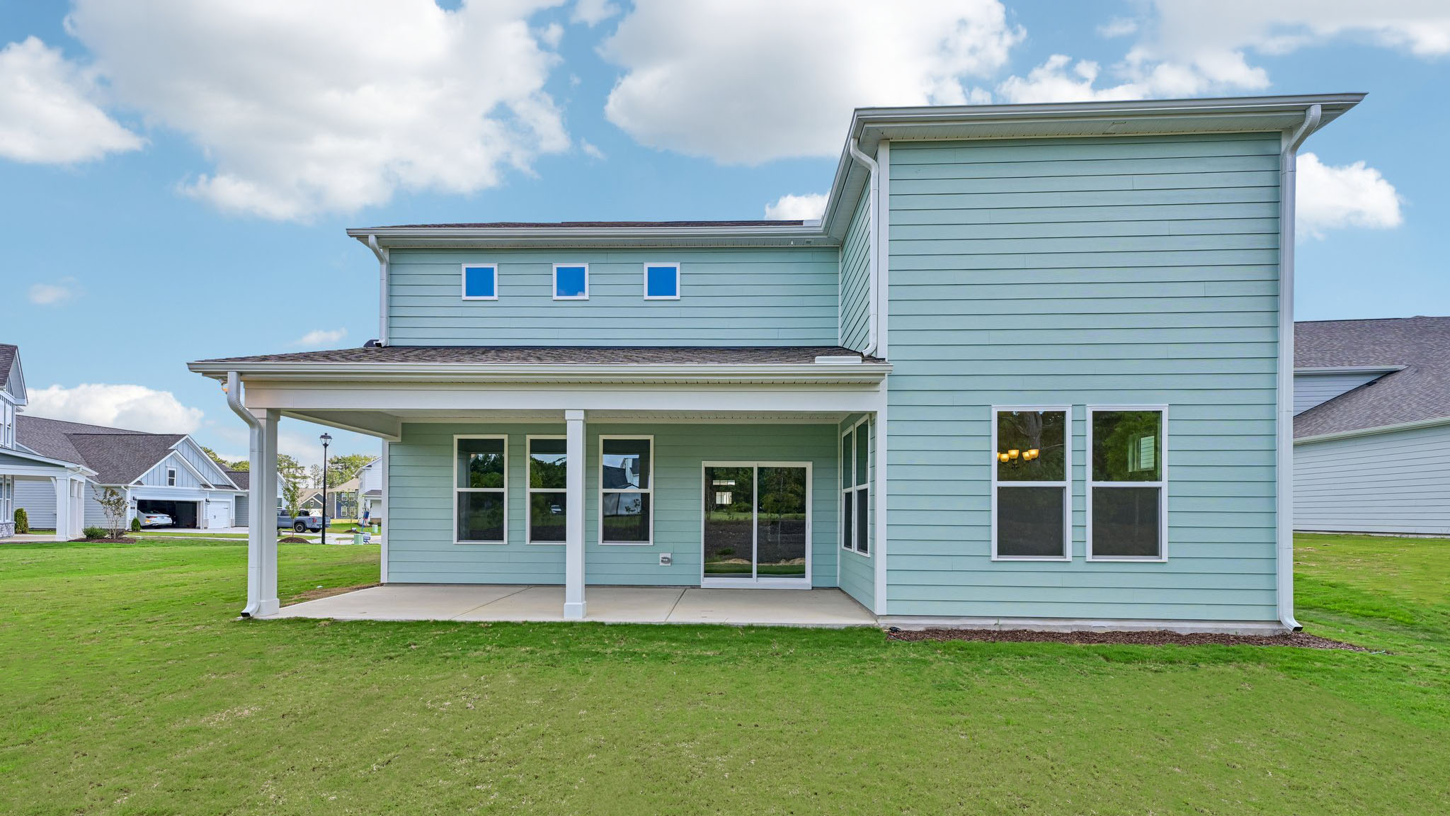 back of home with covered concrete patio