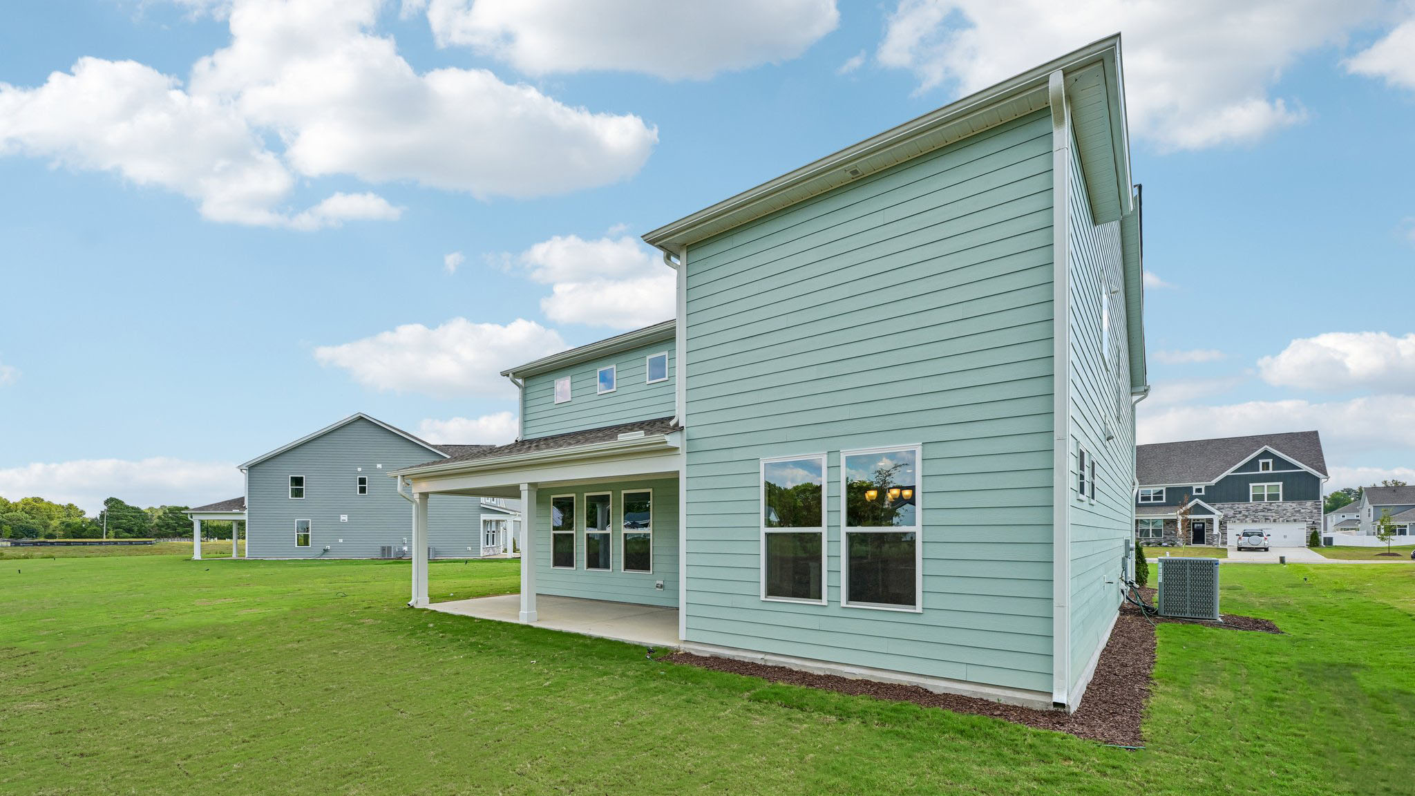 back of home with covered concrete patio