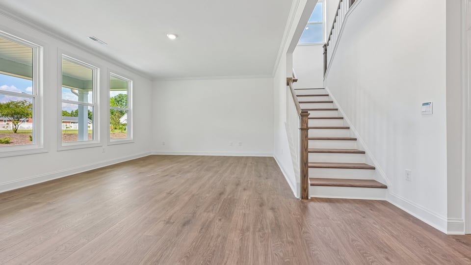 living room with open rail staircase