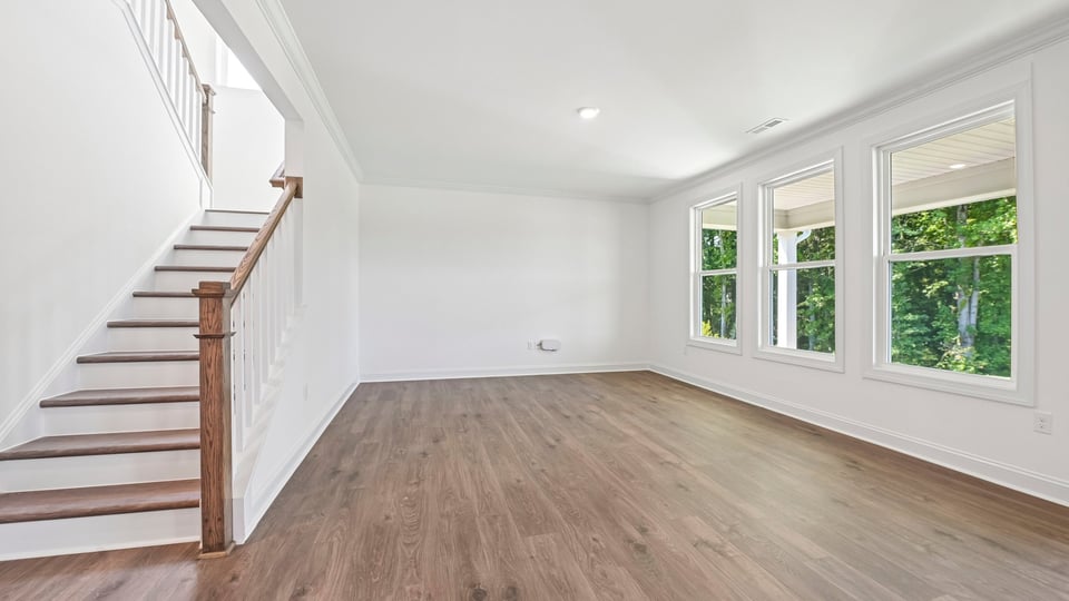living room with open rail staircase