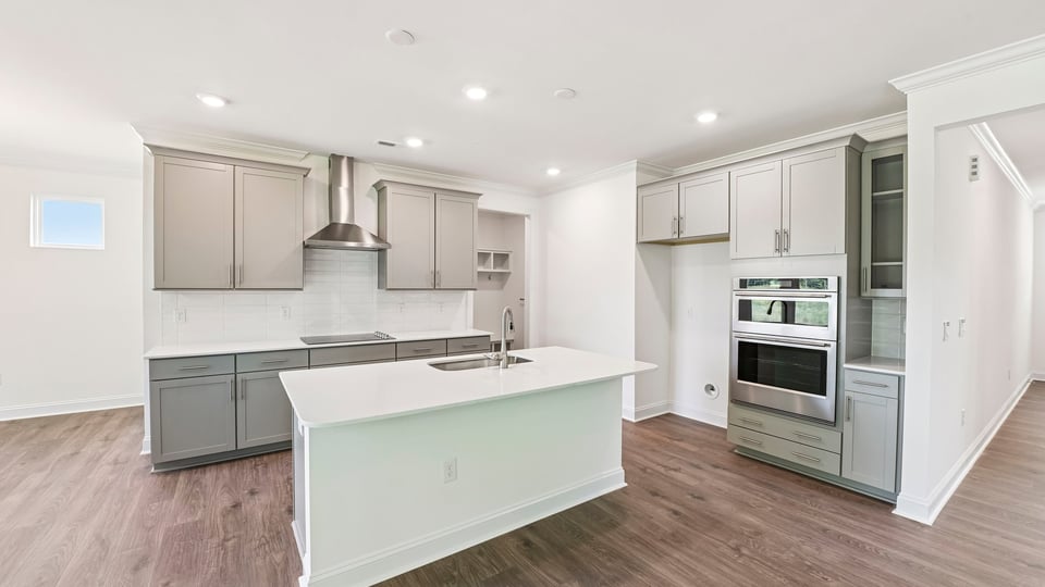 kitchnen with gray cabinets center island and quartz countertops