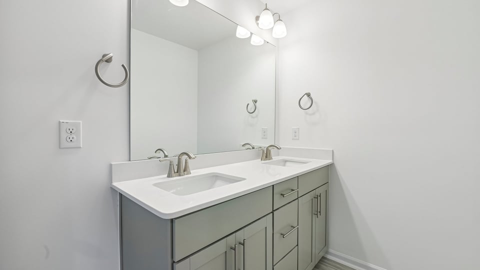 bathroom with gray cabinets and quartz countertops