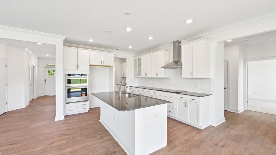 kitchen with white cabinets center island and quartz countertops