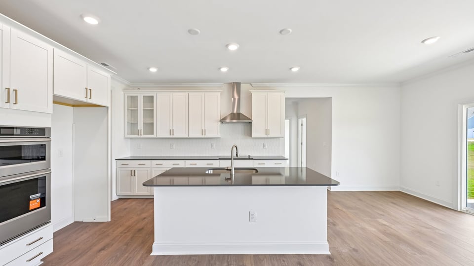 kitchen with white cabinets center island and quartz countertops