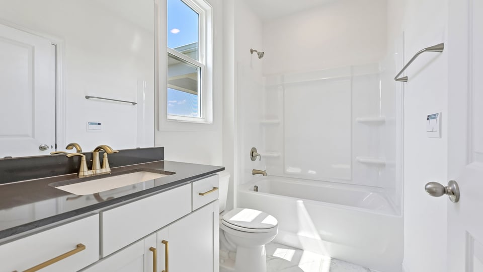 bathroom with tub shower combo and quartz countertops