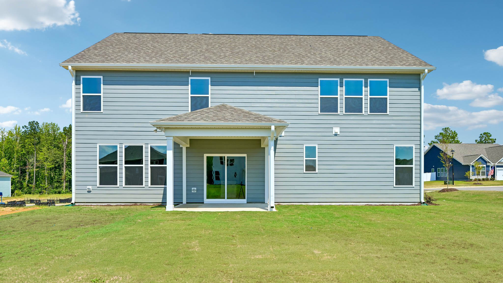back of home with covered concrete patio