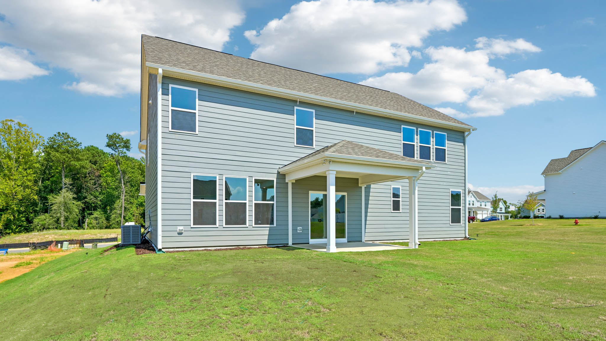 back of home with covered concrete patio