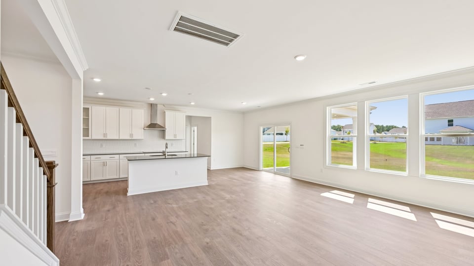 open concept living room overlooked by kitchen