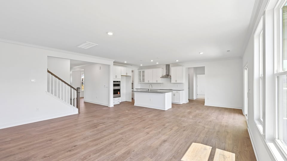 open concept living room overlooked by kitchen