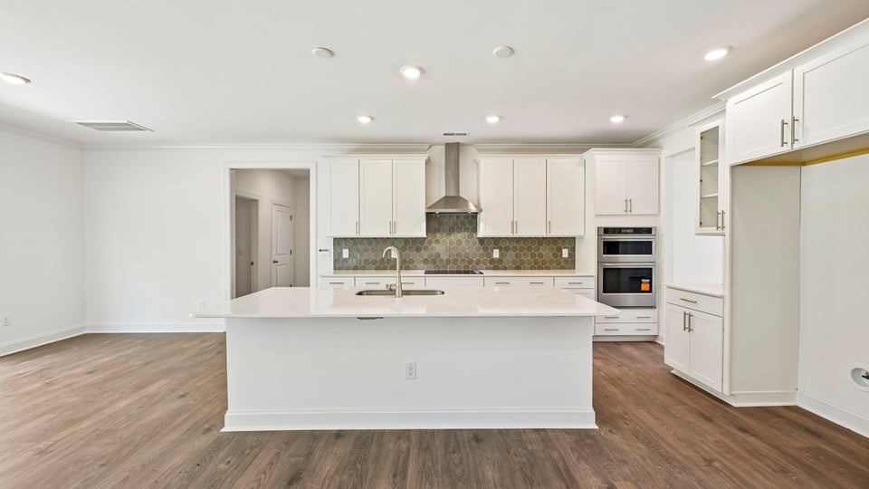 kitchen with white cabinets spacious island and quartz countertops