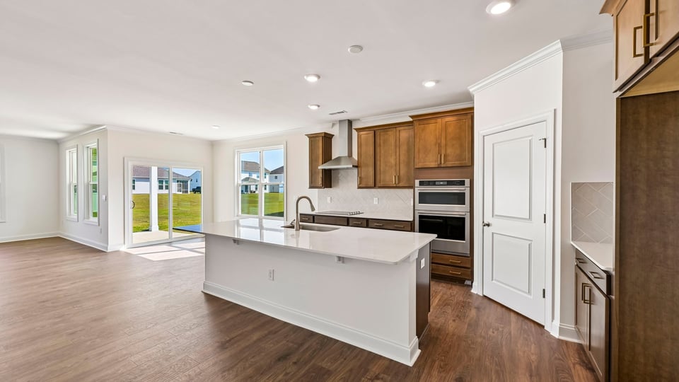kitchen with spacious center island and brown cabinets