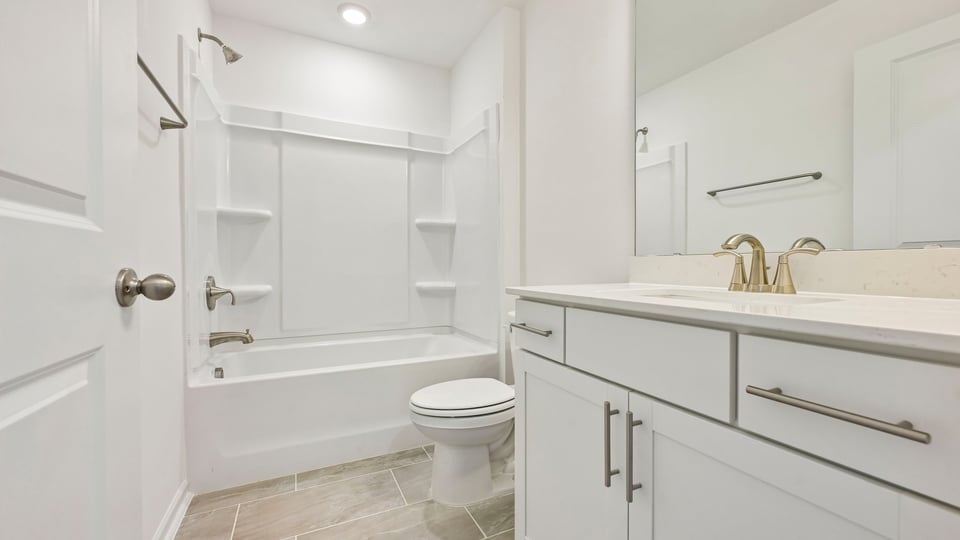 bathroom with tub shower combo and quartz countertops