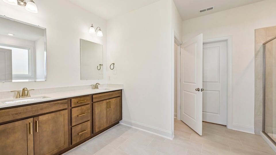 bathroom with brown cabinets and water closet