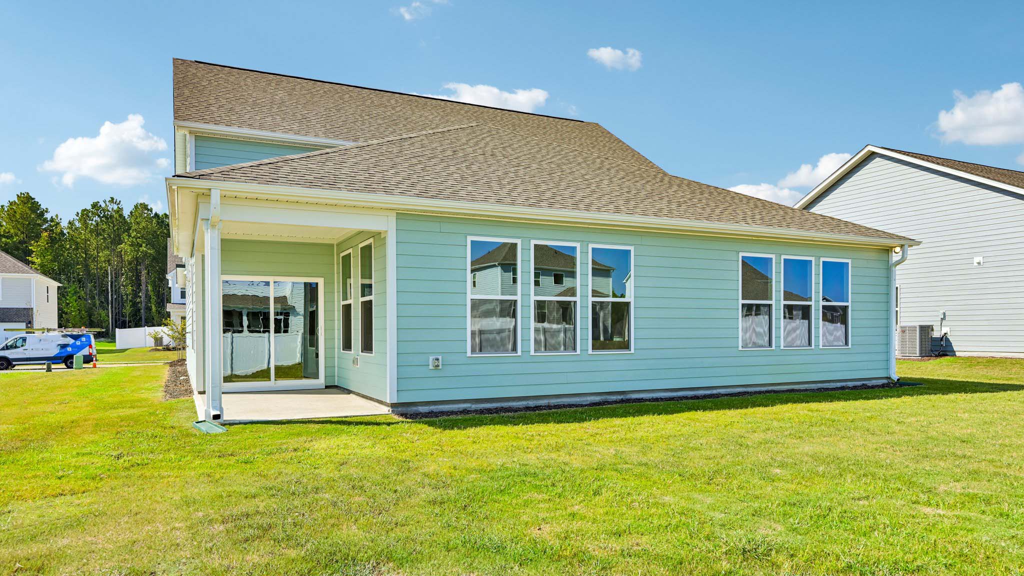 back of home with covered concrete patio