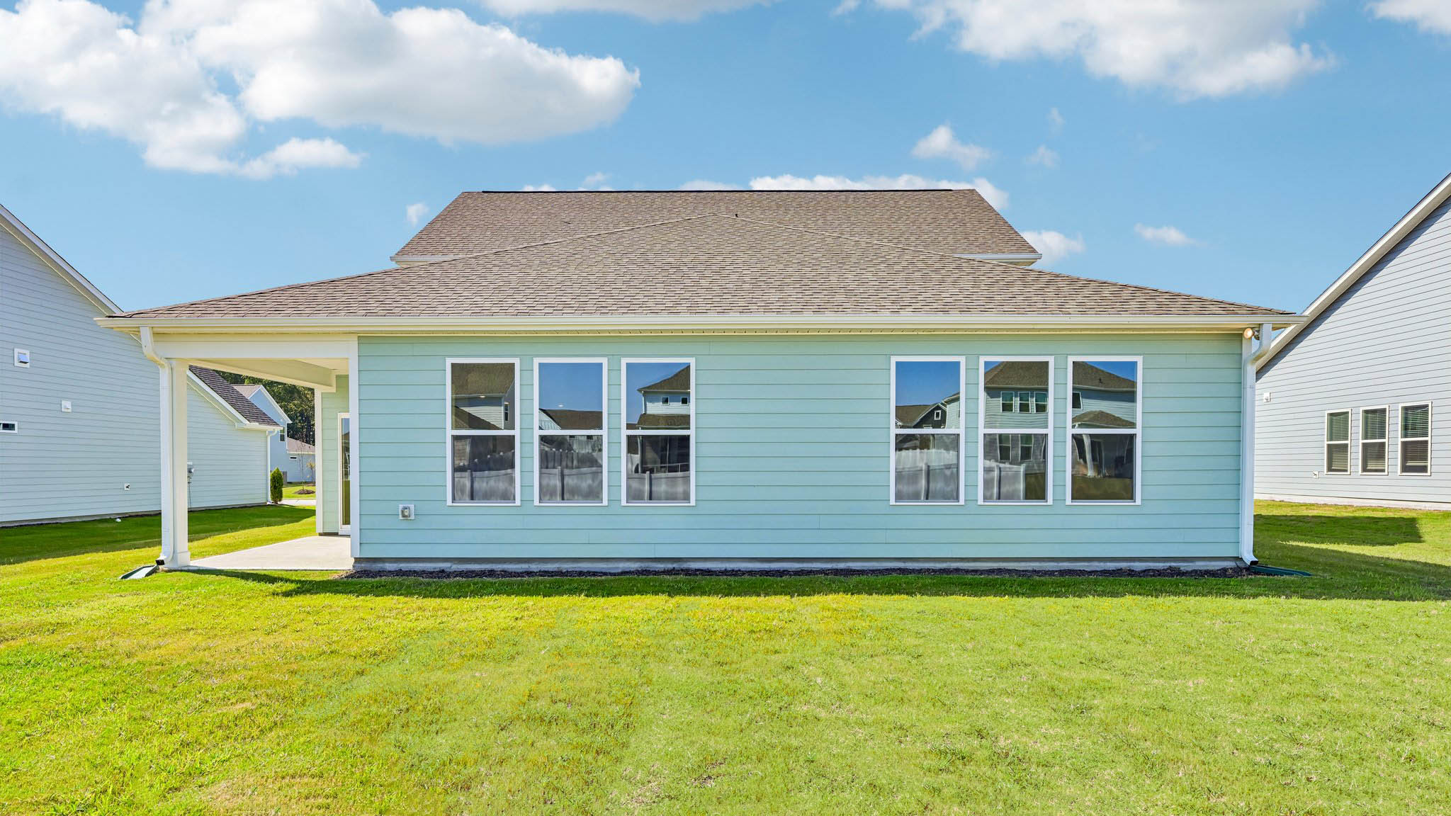back of home with covered concrete patio