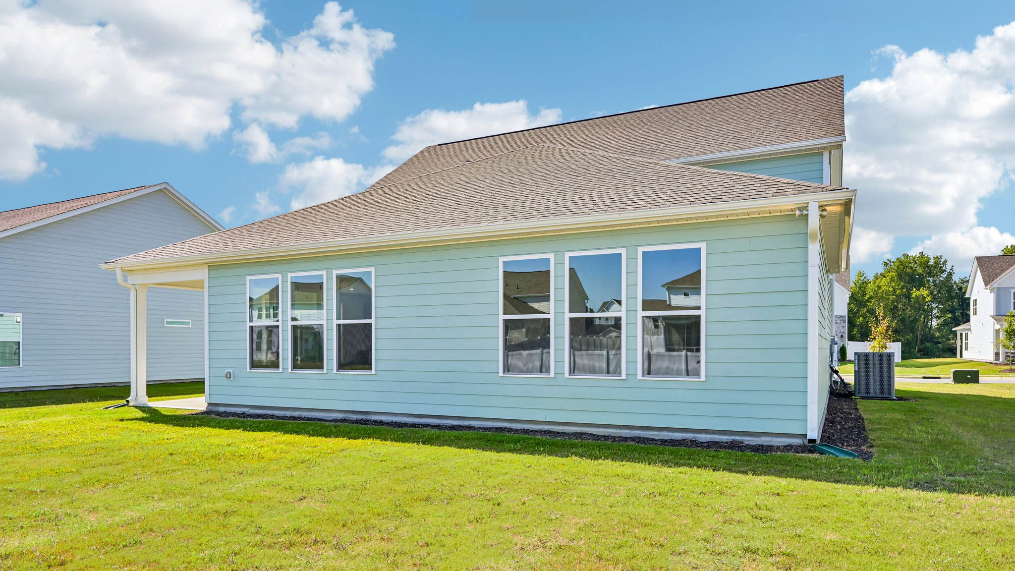 back of home with covered concrete patio