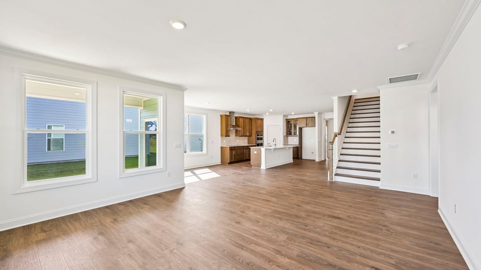 open concept living area overlooked by kitchen