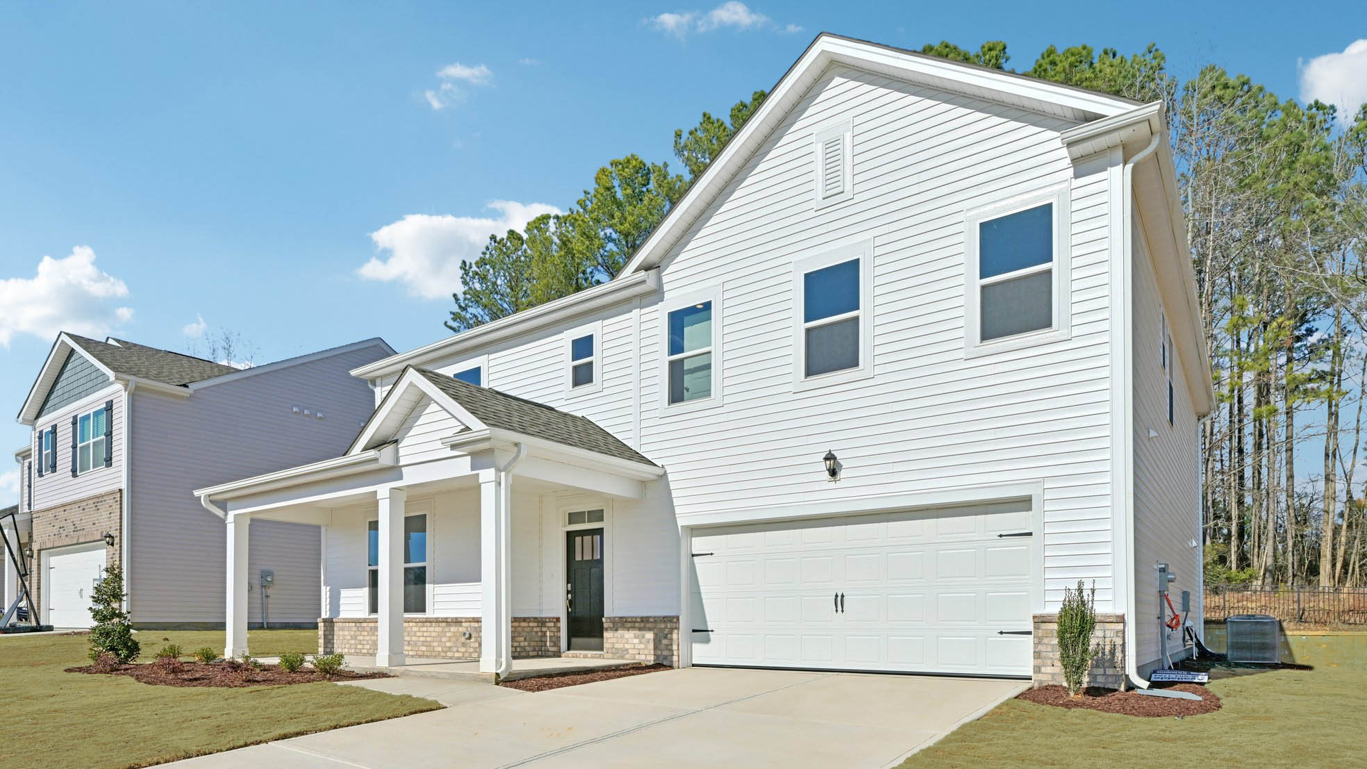 front exterior of wylie b with 2 car garage
