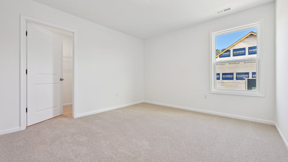 additional bedroom with window, carpeting, closet