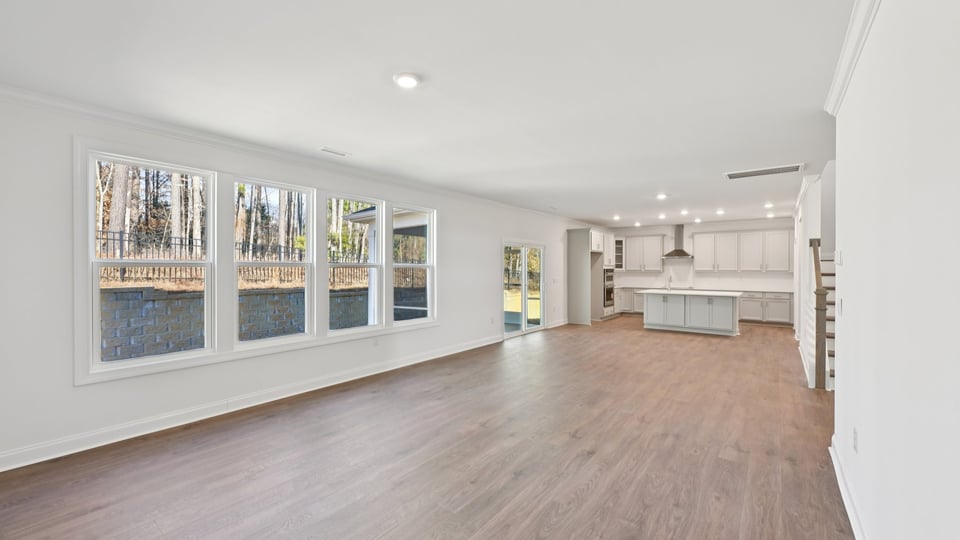 living room with plenty of natural lighting and revwood flooring