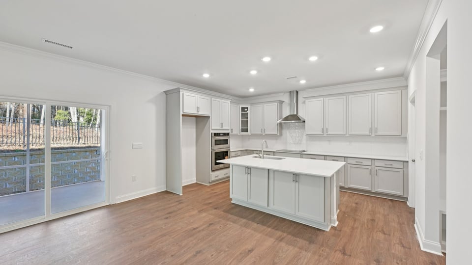 kitchen with island quartz countertops and stainless steel appliances