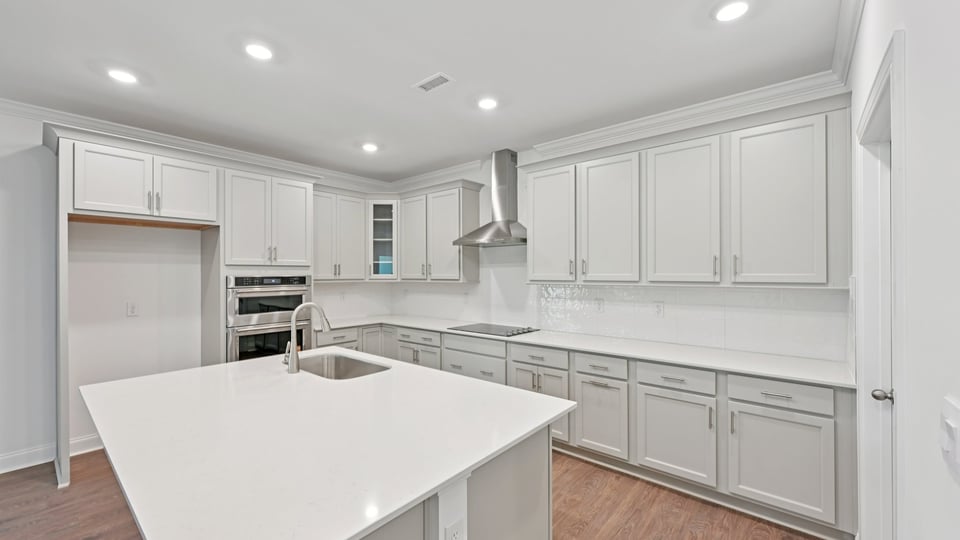 kitchen with island quartz countertops and stainless steel appliances