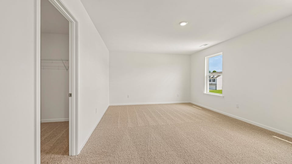 primary bedroom with carpet flooring