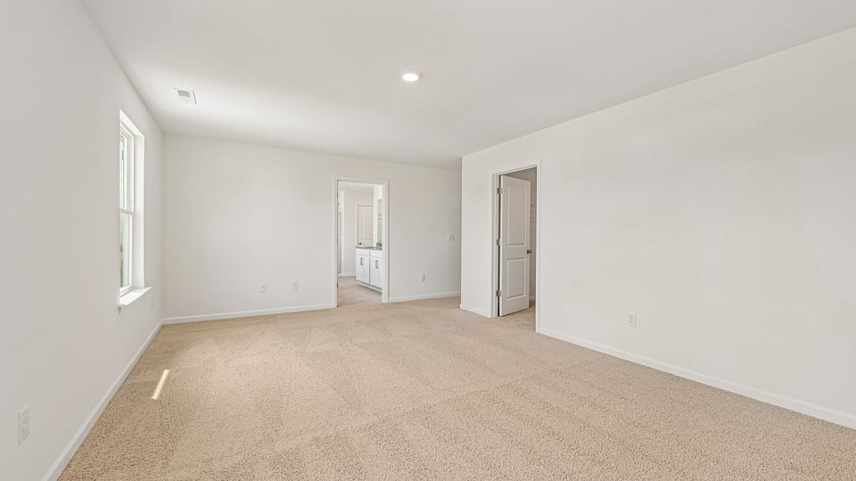 primary bedroom with carpet flooring