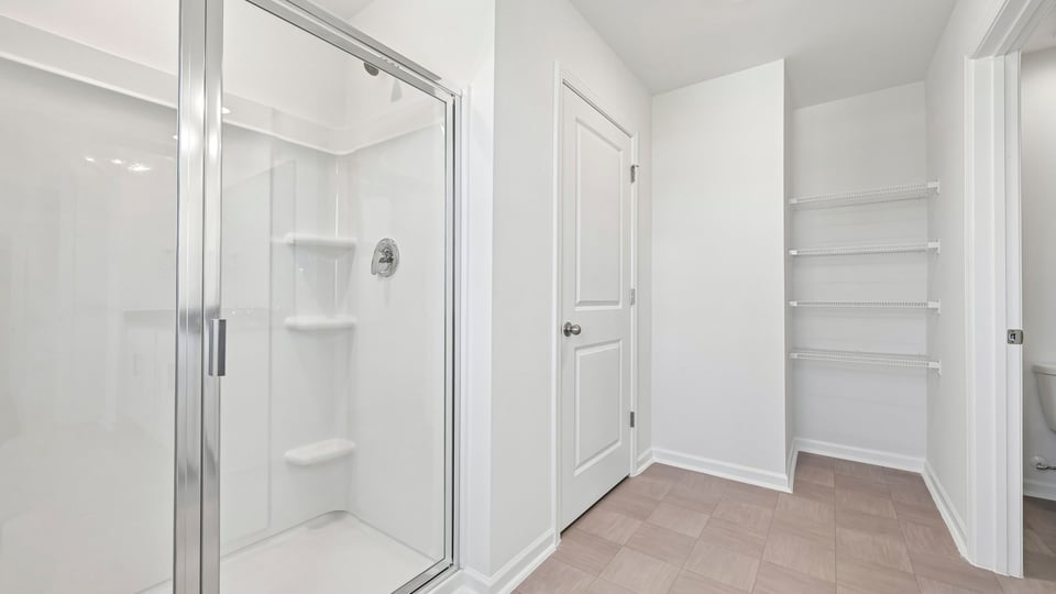 primary bathroom with walkin shower and walkin closet